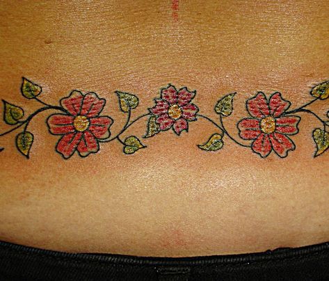 47-tattoo-daisy-chain Daisy Chain Tattoo Ankle, Flower Chain Tattoo, Watercolor Daisy Tattoo, White Daisy Tattoo, Tattoo On Lower Back, Daisy Chain Tattoo, Memorial Tattoos Mom, Daisy Tattoos, Back Tattoos For Women