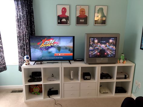 Nice cabinets, how the backs are covered but have cables running back unseen.  The cubes are Kallax units, but they backed them with beadboard to hide the cables. Kallax Gaming Room, Entertainment Center Bedroom, Xbox Setup, Gamer Rooms, Retro Room Ideas, Game Display, Vhs Collection, Video Game Room Decor, Games Room Inspiration