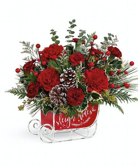 Dashing through the snow in a flower-filled open sleigh! Fun and festive, this vintage metal keepsake sleigh is the perfect vehicle for a joyful holiday bouquet. Red carnations, miniature red carnations and white filler are accented with assorted greens and evergreens and artistically arranged in Vintage Sleigh Ride Keepsake. Approximately 13 1/2" W x 12 1/2" H #FlowerKingdom Vintage Sleigh, Holiday Floral Arrangements, Holiday Bouquet, Holiday Flowers, Christmas Flower Arrangements, Red Carnation, Red Rose Bouquet, Holiday Flower, Holiday Floral