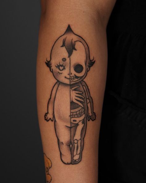 black and white tattoo of a kewpie doll on tan skin. there is a vertical line down the center dividing the kewpie doll in half, like an anatomical model. the left half of the doll is normal, the right half of the doll has exposed bones and organs. Elm Street Tattoo, Dallas Tattoo, Anatomy Tattoo, Street Tattoo, Tattoo Parlors, Ink Master, Neo Traditional, American Traditional, Custom Tattoo