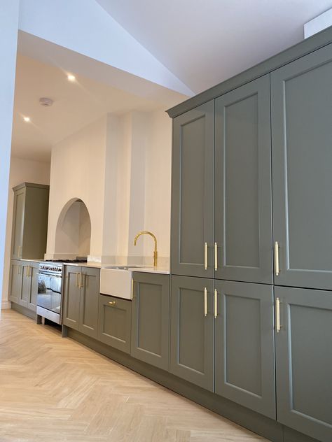 Green Shaker Kitchen. Gold knurled handles. Gold Quooker Tap. Silestone white worktop. Belfast sink. Arch. Sage Shaker Kitchen, Kitchen With Gold Handles, Silestone Worktop, Quooker Tap, Green Shaker Kitchen, Painted Shaker Kitchen, Herringbone Flooring, Belfast Sink, Shaker Style Doors