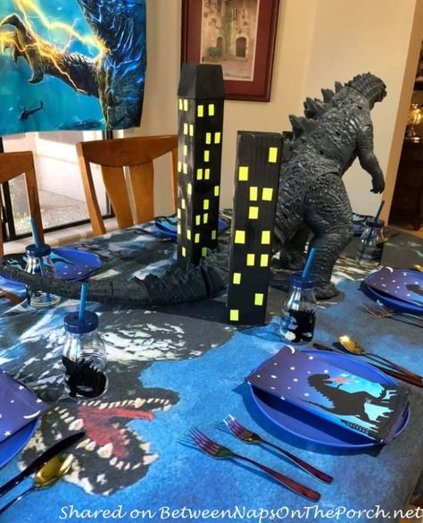 A Godzilla Themed Table Setting Godzilla Centerpieces, Godzilla Themed Birthday Party, Godzilla Party Decorations, Godzilla Party Ideas, Godzilla Room Ideas, Godzilla Birthday Party Decorations, Godzilla Party Games, Godzilla Decorations, Godzilla Party