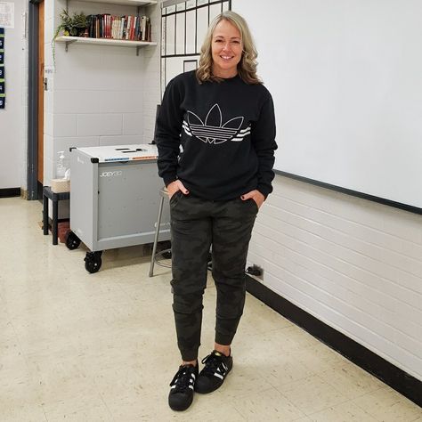 Casual everyday fall winter athleisure sporty teacher outfit featuring an Adidas Originals trefoil pullover sweatshirt, Lululemon camo joggers, and black Superstars sneakers #athleisurewear #athleisure #sporty #athletic #black #teacher #joggers #lululemon #adidas #sneakers #fall #casual Pe Teacher Outfits Female Casual, Gym Teacher Outfits Physical Education, Sports Teacher Outfit, Pe Coach Outfit, Physical Education Outfits, Sporty Teacher Outfits, Teacher Jogger Outfits, Pe Teacher Outfits Female, Gym Teacher Outfits