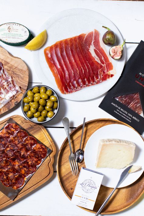 Gather with friends or family and celebrate with La Familia Tapas Selection. Serving 4-6 tapas style, this curated selection of authentic Spanish cured meats, ham, cheese, conservas and more, will create an memorable food experience that everyone will enjoy. La Familia Tapas Selection includes: 250g Chorizo sarta (horseshoe shaped cured chorizo sausage) 100g Sliced salchichón Ibérico (mild cured sausage, similar to salami) 80g Ibérico de Bellota ham 50g Ibérico de Cebo ham 125g Serrano ham 175g Tapas Aesthetic, New Year's Snacks, Spanish Olives, Serrano Ham, Manchego Cheese, Chorizo Sausage, Food Experience, Miami Gardens, Ham Cheese