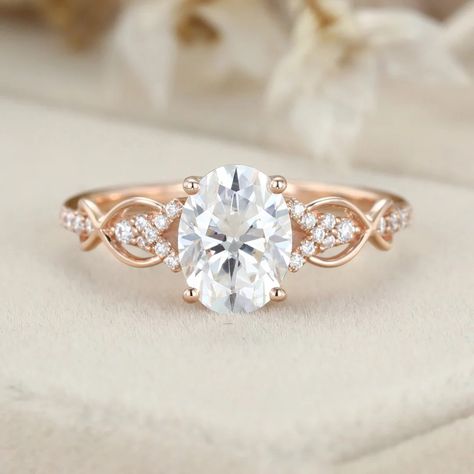 This stunning 1.5ct oval-shaped Moissanite engagement ring is a unique vintage piece that is sure to turn heads. Crafted in rose gold, the twist wedding ring design adds a touch of elegance and sophistication. Weddinv Rings, Engagement Rings Rose Gold Band, Classy Engagement Ring Vintage, Wedding Rings Silver Unique, Simple Gold Band Engagement Ring, Oval Engagement Ring Settings, Engagement Rings Nature, Oval Engagement Ring Rose Gold, Twist Wedding Ring