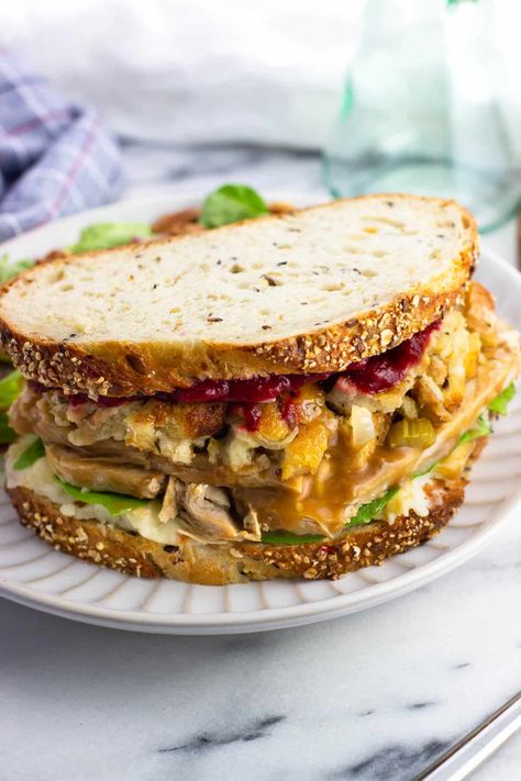 Faced with a mountain of leftover Thanksgiving food? Make a leftover Thanksgiving sandwich! This loaded turkey sandwich features gravy, stuffing, cranberry sauce, and even mashed potatoes for a hefty, hearty way to repurpose this traditional holiday fare. Turkey Stuffing Sandwich, Turkey Melts, Leftover Turkey Sandwich Recipes, Leftover Sour Cream, Spicy Cranberry Sauce, Turkey Sandwich Thanksgiving, Stuffing Cranberry, Leftover Thanksgiving Sandwich, Thanksgiving Sandwich