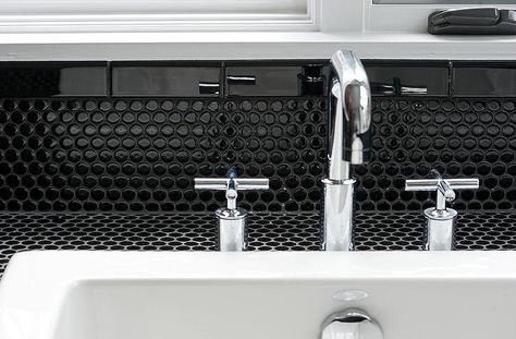 Black and white bathroom features washstand countertop tiled in black penny tiles accented with contrasting white grout fitted with a white vessel sink and polished nickel faucet as well as a black penny tile backsplash finished with black grout. Black Penny Tile, Penny Tile Backsplash, White Beveled Subway Tile, Black Bathroom Floor, Penny Tiles Bathroom, Penny Tiles, White Vessel Sink, Wolf Den, Beveled Subway Tile