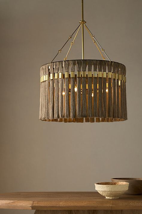 Anchored by matching hook and loop hardware, this elegant drum-shaped light draws its inspiration from the braids and tassels of ancient Greece. A flourish of silken gold and gray fringe is threaded, gathered and bound by shimmering antique brass hardware, giving this impactful fixture a timeless appeal. This item is UL listed, meaning it has been tested and approved to meet the government-regulated safety standards for the USA. Use with electrical outlets 110-120v or lower, as anything higher can cause fire or injury. If you're purchasing this item for use outside of the United States, employ the adapter and voltage converter suited for your country. | Dutchess Chandelier by Anthropologie in Gold Unique Lamp Shades, The Dutchess, West Home, Unique Lamp, Antique Brass Hardware, Unique Lamps, Electrical Outlets, Ancient Greece, Sloped Ceiling