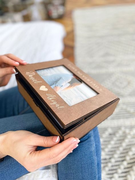 Wooden Photo box is a good idea for those who like to keep the best memories in the form of photos. You can also give it as a gift to your near and dear ones. There are so many occasions to give it as a gift: Weddings, Valentine's Day, Christmas, anniversaries, birthdays, etc. In any case, you will get not only a thing, but also positive emotions and happiness about the occasion. It will fit a 6" x 4" (10x15 cm) landscape photograph. Such present will look good for a long time. Wedding Photo Box, Wooden Photo Box, Christmas Photo Album, Wooden Memory Box, Engraved Box, Wedding Box, Photo Box, Anniversary Gifts For Couples, Valentine Box