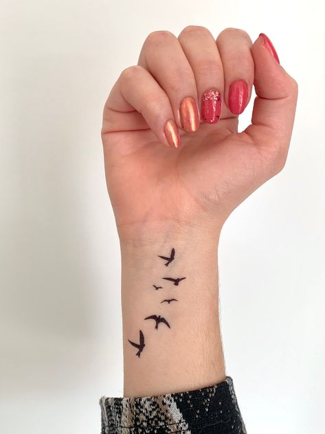 "1 'flying birds' tattoo Size: the tattoo is around 6,5 cm (2.56\") Last for 2-7 days, depends were you place the tattoo and how much you wet the tattoo. Your order includes an application instruction You can remove your tattoo by rub the tattoo of with oil or alcohol Don't forget to share your picture with us on instagram and get featured: @tattoodayco ------------------------------------------------------------------------------------------------------------------- Processing time: Orders will Tattoo Ideas Female Birds Flying, Birds Going Up Arm Tattoo, Bird Flock Tattoo, Small Birds Flying Tattoo, Tattoo Birds Flying, Flock Of Birds Tattoo, Birds Tattoo Design, Birds Flying Tattoo, Flying Birds Tattoo