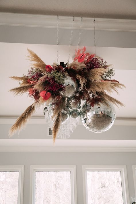 Disco Ball And Pampas, Disco Ball Pampas Wedding, Pampas Grass And Disco Balls, Flower And Disco Ball, Pampas Disco Ball, Disco Ball Ceiling Installation, New Years Eve Flowers, Disco Ball Florals, Disco Ball Floral Installation