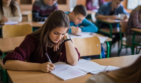 A high school student writes in a notebook in class College Classroom, Writing Conferences, Topic Sentences, Cell Phone Service, Station Activities, Education Organization, Education Kindergarten, Math Videos, Education College