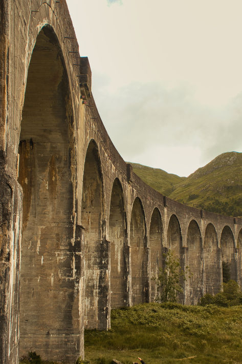 A curved concrete bridge. Glenfinnan Viaduct, Scotland Landscape, Scotland