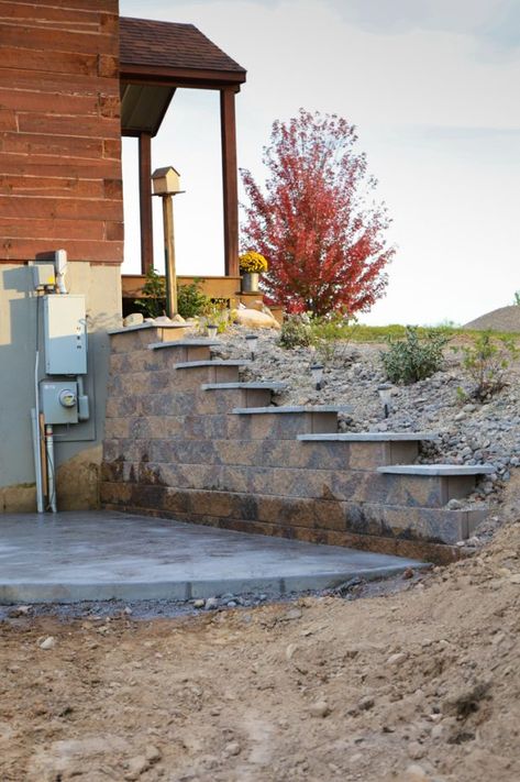 Walkout Basement Fire Pit, Walkout Basement Landscaping Ideas, Daylight Basement Landscaping, Walkout Patio Under Deck, Walkout Basement Retaining Wall Ideas, Basement Retaining Wall Ideas, Deck With Retaining Wall Under, Basement Walkout Ideas Retaining Walls, Walkout Basement Patio Ideas