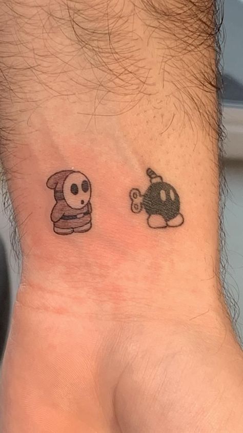 Shy Guy Mario Tattoo, Easy Outline Tattoo Ideas, Shy Guy Tattoo Design, Mario Matching Tattoos, Bob Omb Tattoo, Small Mario Tattoo, Shy Guy Tattoo, Cars Tattoo Disney, Rapper Tattoos Ideas