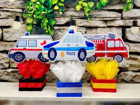 "First Responder Birthday Theme | First Responder Party Decoration | Fire Truck Party | Police Birthday | Ambulance Decoration |SET OF 3 These centerpieces are FULLY ASSEMBLED, DECORATED, and ready to be displayed! They are completely handcrafted and made with attention to detail. Matching ribbon is attached around the base, and decorated with tissue paper! Video is only for you to view size, finish, and assembly of centerpieces. You will receive the theme in the listing This listing is to purchase all the centerpieces pictured! With your purchase, you will receive the following... 1 Fire Truck Centerpiece 1 Police Car Centerpiece 1 Ambulance Centerpiece If you need a different amount, message us for a custom invoice IF YOU WOULD LIKE TO PURCHASE INDIVIDUAL PIECES, YOU MAY DO SO HERE.... h First Responder Birthday Party, Ambulance Birthday Party, Car Centerpieces, Guest Table Centerpieces, Police Party, Police Birthday, Fire Truck Party, Paper Video, Party Tablescapes