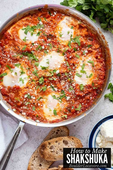 Easy Shakshuka recipe: spicy homemade tomato-vegetable sauce with eggs poached in it, topped with crumbled cheese and cilantro or parsley. Crusty bread for dipping! Ready in 30 minutes without much active cooking time. Easy Shakshuka Recipe, Easy Shakshuka, Bread For Dipping, Eggs Poached, Shakshuka Recipe, Shakshuka Recipes, Easy Breakfast Recipe, Egg Dishes, Eggs Recipe