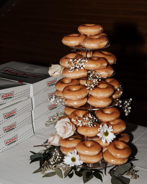 A Krispy Kreme donut tower with added wedding florals. Wedding Krispy Kreme, Wedding Doughnut Tower, Krispy Kreme Donut Tower, Wedding Cake Donut Tower, Fun Wedding Dessert Ideas, Donuts At Wedding, Krispy Kreme Wedding Cake, Krispy Kreme Donut Cake, Krispy Kreme Wedding