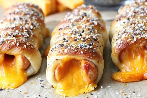 A fantastic way to elevate your hot dogs is to turn them into Everything Bagel Pretzel Cheese Dogs. These are made with cheddar stuffed hot dogs wrapped in store bought pizza dough. To transform into pretzels is easy—quickly boil in a baking soda solution, apply egg wash, sprinkle on everything bagel seasoning, then bake.Serve these dogs as is because they are delicious alone, but you can certainly enjoy them with your favorite condiment. They are perfect for lunch, a simple supper, ki… Stuffed Hot Dogs, Hot Dog Pizza, Pretzel Dogs, Store Bought Pizza Dough, Pretzel Cheese, Everything Bagel Seasoning, Cheese Dog, Bagel Seasoning, Lentil Stew