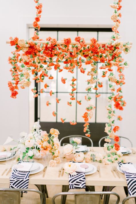 Holy moly, me-oh-my! This modern floral installation has stolen our hearts! No better way to decorate a bridal shower tablescape than with drippy carnations, patterned napkins and a fiber art backdrop for all the selfies. This collaboration has some serious fashion goals too! #ruffledblog Wedding Floral Hanging Installation, Hanging Floral Installation, Floral Installation, Hanging Floral Installation Wedding Tent, Tent Floral Installation, Bridal Shower Tablescape, White Floral Hanging Installation, Bright Hanging Floral Installation, Hanging Centerpiece