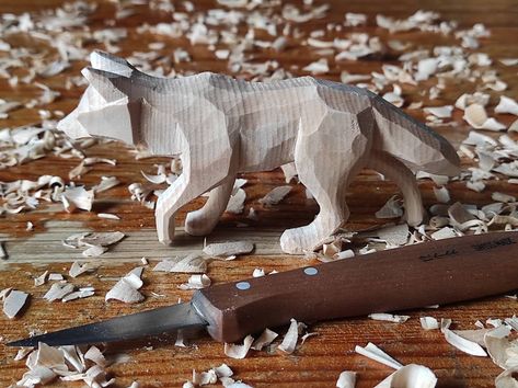 This wolf has been carved out of swiss pine using only a knife in order to get a simple minimalist style. The piece has been finished with bees wax.