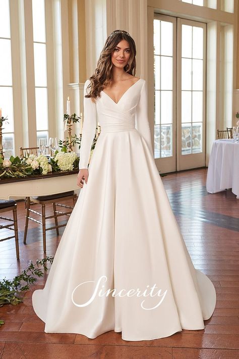 This long sleeve Mikado ball gown is a dress that will make you feel like royalty. It features a modest V-neckline with an open V-back. Pleating along the bodice slims the waistline and leads to a full, circular cut skirt. Pockets and covered buttons to the end of the chapel length train are the finishing touches to this charming bridal gown. Long Sleeve Silk Wedding Dress, Sincerity Bridal, Filipiniana Dress, Civil Wedding Dresses, Skirt Pockets, Beach Wedding Dress Boho, Wedding Dress Boutiques, Justin Alexander, Princess Wedding Dress