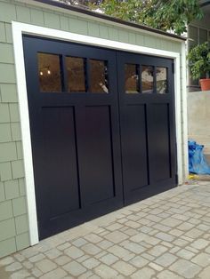 61+ Amazing Garage Door Ideas including One, Two, and Three Door Designs and Sectional, Carriage, Modern, Rustic, and Sliding Door Styles. Craftsman Style Garage Doors, Black Garage Door, Black Garage Doors, Sliding Garage Doors, Carriage Garage Doors, Black Garage, Garage Tile, Modern Garage Doors, Garage Floor Paint