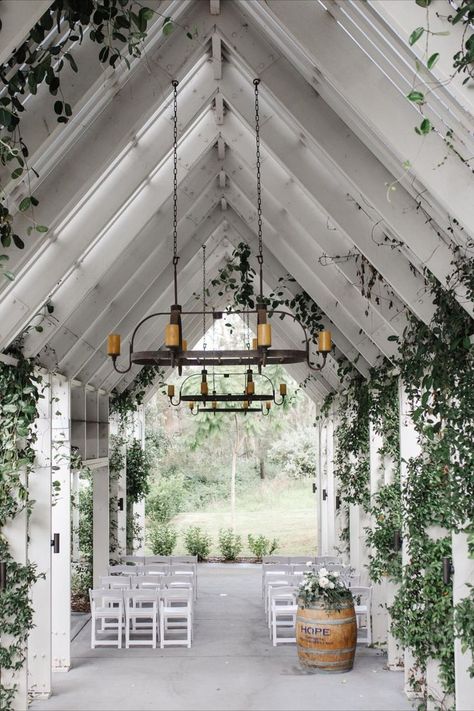 Small wedding venue in a chapel-like open air area with white beams & roof, rustic candle chandeliers and white seating on concrete floor. Library Wedding Venue Ideas, Wedding Venues Nsw, Australian Wedding Venues, Small Wedding Venue Ideas Indoor, Sydney Wedding Venues, Small Wedding Venues Indoor, Small Event Venue Design, Small House Wedding, Small Venue Space