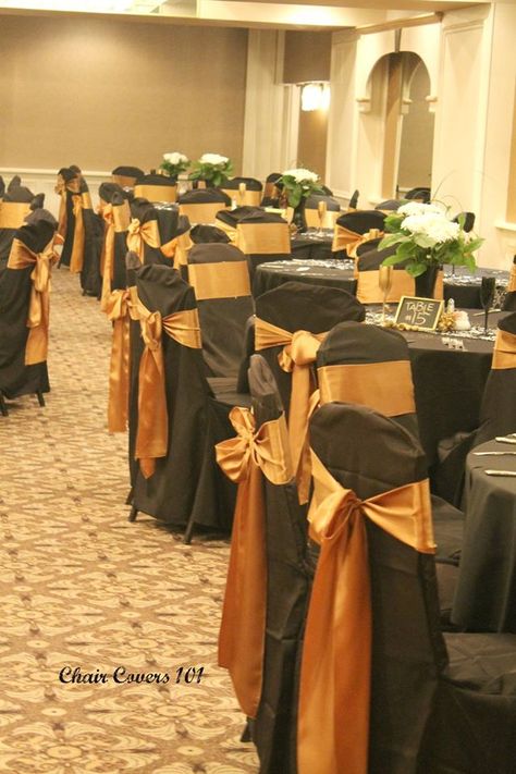 Black banquet chair cover with antique gold satin sash Orange Black And Gold Party Decor, Athletic Centerpieces, Black Chair Covers, Black Brides Hairstyles, Brides Hairstyles, Orange Weddings, 30th Birthday Bash, Surprise Birthday Decorations, Black Brides