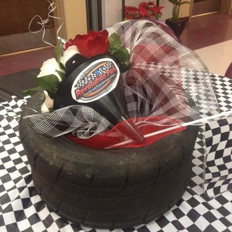 Racing Theme Centerpiece.                         (Made by original pinner) #racing #nascar Racing Theme Graduation, Racing Banquet Ideas, Tire Centerpiece, Nascar Wedding, Nascar Crafts, Retirement Centerpieces, Indy 500 Party, Track Banquet, Checkered Wedding