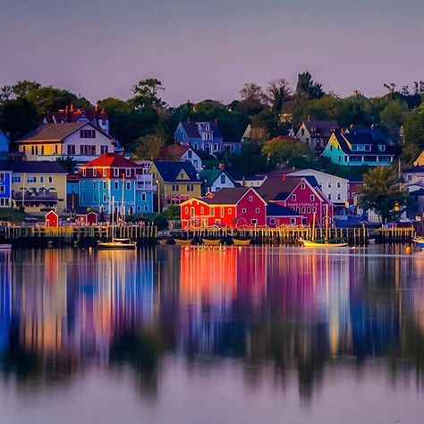 Sunset over the colourful fishing village of Lunenburg, Nova Scotia. The town of Lunenburg is a UNESCO World Heritage site and is a place you cannot miss on the south shore of Nova Scotia. If you drive to the opposite side near the golf course you get a beautiful view of the harbour. (credit: theplanetd via instagram) Quebec Travel, East Coast Canada, Lunenburg Nova Scotia, Nova Scotia Travel, Lovely Houses, Visit Nova Scotia, Dreamy Destinations, Canada Trip, Maritime Art