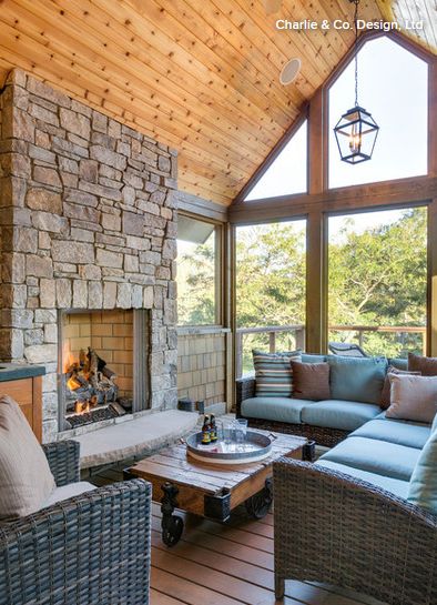 A look inside the second-story screened-in porch, which has a vaulted knotty pine ceiling and a stone surround on the fireplace. Pine Vaulted Ceiling Living Room, Pine Ceilings Vaulted, Knotty Pine Vaulted Ceiling, Pine Wood Ceiling Living Room, Knotty Pine Ceiling Living Rooms, Pine Ceiling Vaulted, Pine Ceilings, Knotty Pine Ceiling, Pine Ceiling