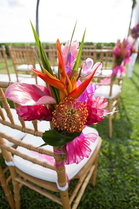 Chair Flowers for the Aisle Chairs. Aisle Decor for Saori and Edmund's Paradise Cove Wedding planned by Hawaii Weddings by Tori Rogers. Flowers by The Blooming Pot. Photo by Michelle Scotti. www.hawaiianweddings.net Tropical Ceremony Aisle, Colorful Wedding Flower Arrangements, Hawaii Wedding Decor, Hawaiian Wedding Decor, Tropical Wedding Table Decor, Tropical Wedding Party, Tropical Flowers Wedding, Tropical Chic Wedding, Tropical Wedding Ceremony