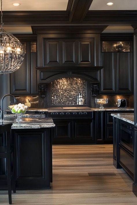 Modern kitchen with dark cabinetry, granite countertops, a mosaic tile backsplash, and a large glass chandelier. Modern Gothic Kitchen Interior Design, Country Kitchen Black Cabinets, Black Cabinets With Granite Countertops, Dark Castle Kitchen, Dark Modern Kitchen Design, Big Dark Kitchen, Dark Theme Kitchen, Kitchen Remodel Black Cabinets, Gothic Farmhouse Kitchen