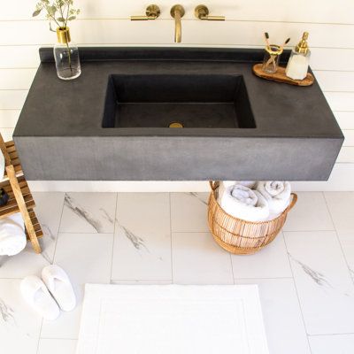 A wall-hanging bathroom vanity with metal bracing and 9'', 100% glass fiber reinforced concrete top. The integrated sink and two-part sealer make for easy clean-up and lifelong durability. Also includes integrated 2'' backsplash. Our box style sink fits any standard drain and a plumbing nut is attached to the underside for easy plumbing hook-up. Brackets are included and mount to wall studs; hardware for mounting is included and any construction adhesive will firmly attach concrete top to bracke Concrete Shower Pan, Vanity With Backsplash, Concrete Shower, Concrete Vanity, Floating Sink, Powder Room Sink, Concrete Bathroom, Wall Mount Sink, Concrete Sink