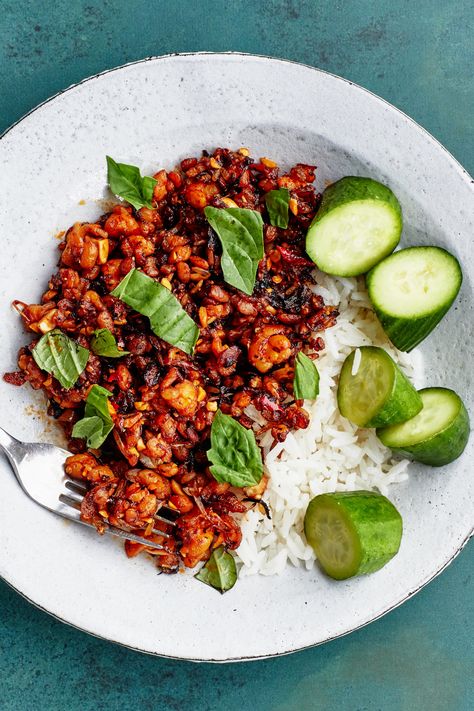 When crumbled into pea-size pieces, tempeh cooks fast and sizzles into crispy nubbins in the process. And when you add roasted peanuts and store-bought chili crisp, the textural allure goes off the charts. Of course, you’ll need something to offset that spiciness—the creamy coconut rice and quick-pickled cucumbers offer cooling relief between bites. Bon Appetit Recipes, Coconut Rice Recipe, Veggie Dinners, Chili Crisp, Tempeh Recipes, Quick Pickled Cucumbers, Vegetarian Mains, Weekly Meal Planning, Weeknight Recipes