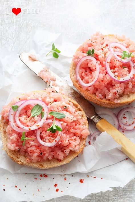 Mettbrötchen is a type of sandwich consisting of a fresh brötchen (a German bread roll) and mett (raw pork mince). The bread roll is sliced, then topped with a layer of mett, which is usually seasoned with salt and pepper and garnished with slices of raw onions on top. This sandwich is a typical breakfast item in Germany, and it is typically enjoyed in northern parts of the country. Interestingly, Mettwoch is a German custom of savoring mettbrötchen on Mittwoch (Wednesday). German Sandwiches, Hungarian Dishes, Austrian Cuisine, Genshin Oc, Raw Pork, Germany Food, German Bread, German Foods, Types Of Sandwiches