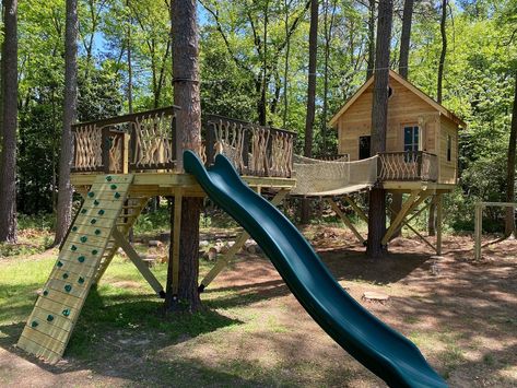 Treehouse net railing rope railing treehouse loft cedar siding suspension bridge Tree House Between 2 Trees, Tree House With Bridge, Platform Treehouse, Family Backyard Design, Canada Cabin, Backyard Treehouse, Backyard Play Spaces, Rope Railing, Treehouse Ideas