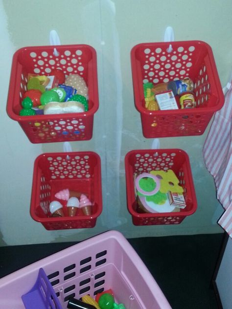 We set up a play kitchen in our garage for our 3 year old and this is how we organized her play food; Command strips and Dollar Store bins....less than $10! She goes "shopping" with her grocery cart and takes the food over to her kitchen. She loves it! Play Food Storage, Playroom Addition, House Organization Ideas, Baby Food Organization, Toddler Room Organization, Girls Room Organization, Dollar Store Bins, Playroom Inspiration, Kids Organization