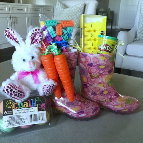 Rain Boots Easter Bucket    Grab some new Rain Boots for your kids and fill them with Easter grass and a few fun items you know they’ll love! I used Peeps, Play-Doh, a Carrot Jump Rope and Building Blocks. I added the Easter Egg Chalk and the little bunny since it wouldn’t all fit in the Rain Boots Rainboot Easter Basket Ideas, Rain Boot Easter Basket Ideas, Rain Boots Easter Basket, Rain Boot Easter Basket, Basket Themes, Unique Easter Baskets, Creative Easter Baskets, Easter 2024, Basket Diy