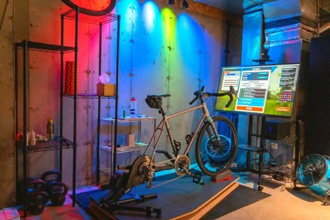 Indoor-Cycling-Pain-Cave Cycling Room Ideas, Cycling Room At Home, Cycling Studio Design, Bike Room Ideas Cycling, Pain Cave Cycling, Zwift Cycling Setup Garage, Cycling Room, Bike Cave, Zwift Cycling