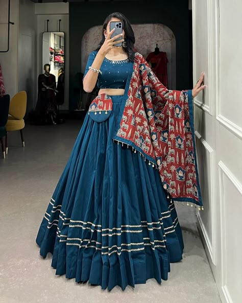 Dance through Navratri nights in this beautifully printed pure cotton lehenga choli. Complete with a matching purse and intricate coin lace detailing, it's perfect for the celebrations! 🥰 *Lehenga (Stitched)* Lehenga Fabric : reyon Cotton Lehenga Work : Plain With Gota Patti Touch Up Lehenga Waist : Support Up To 42 Lehenga Closer : Drawstring With Zip Stitching : Stitched With Canvas Length : 41 Flair : 6 -7 Meter Inner : Micro Cotton *Blouse (Unstitched)* Blouse Fabric : reyon Cotton ... Coin Lace, Cotton Lehenga Choli, Mirror Hand Work, Zip Stitching, Chaniya Choli Designs, Garba Dress, Simple Lehenga, Choli Dress, Navratri Dress