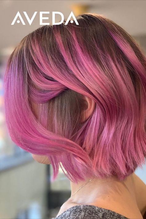 You can show off a glam hairstyle and accentuate your colorful side with this wavy, pink bob hairstyle. Keep a shadow root for a sophisticated hair melt. Beyond the spectrum of vibrant colors an Aveda Artist can hand-create for you, are so many different techniques and placements to choose from. Click to find the look you love. Aveda Artist @minhwaleehair #GlamHair #PinkHair #ShortHair #HomecomingHair #AvedaVibrantColor #ShortHairIdeas #HairInspo Half Shaved Pink Hair, Fashion Color Bob Hair, Pink Hair Natural Roots, Short Shadow Root Hair, Colored Hair With Natural Roots, Rooty Pink Hair, Vivid Hair Color Bob, Short Pink Hair Dark Roots, Short Pink Bob Hairstyles