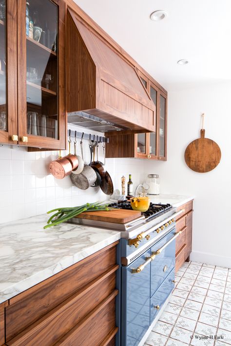 Beautifully updated Tudor kitchen with custom walnut cabinets and Lacanche range. Counters are calacatta marble, Tabarka hand-painted tiles are on th floors, and the star is the Lacanche Saulieu range in Armor. We love the hanging pots, too!  Design by Distinctive Kitchens Seattle Modern Walnut Kitchen, Walnut Kitchen Cabinets, Tudor Kitchen, Walnut Kitchen, Refacing Kitchen Cabinets, Cabinet Refacing, Kitchen Glass, Walnut Cabinets, New Kitchen Cabinets