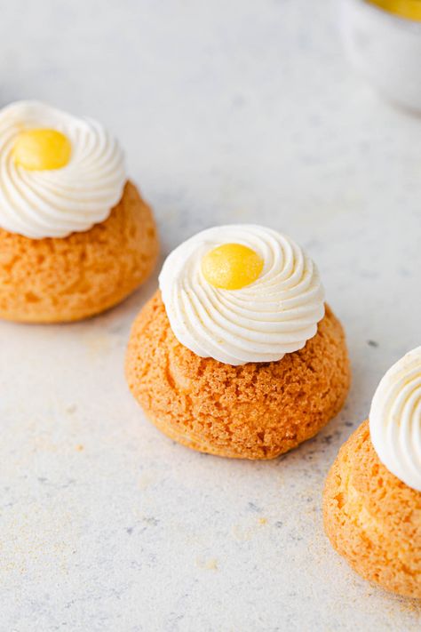 These Paris style lemon cream puffs will have everyone wanting more! These lemon puffs are made with craquelin, pate a choux, lemon curd, and stabilized whipped cream. You can make them with or without the extra whipped cream and curd on top. Either way, these are impressive cream puffs! I often take my inspiration from Paris patisseries where you can buy choux pastries, craquelin, and cream puffs. Lemon Cream Puffs, Cream Puff Dough, Stabilized Whipped Cream, Cream Puff Recipe, Choux Pastry, Paris Style, Pastry Cream, Lemon Cream, Lemon Meringue