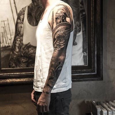 Tattoo uploaded by Ross Howerton | This Spartan warrior is marching into deadly combat in this killer hyperrealist sleeve by Niki Norberg (Instagram @niki23gtr) that also depicts a noble lion. #blackandgrey #hyperrealism #lion #NikiNorberg #sleeve #Spartan | 188404 | Tattoodo Lion Warrior Tattoo, Lion Warrior, Warrior Tattoo Sleeve, Gladiator Tattoo, Spartan Tattoo, Armor Tattoo, Greek Mythology Tattoos, Warrior Tattoos, Wing Tattoo