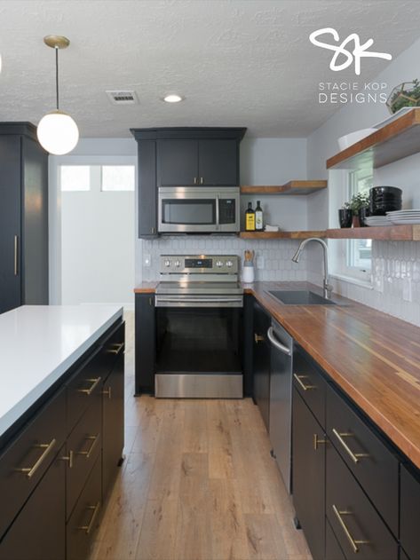 Black Cabinets, butcher block counters, quartz waterfall counter on island, open shelving || Designed by Stacie Kop Designs #kitchendesign #kitchenideas #kitchen #midmodkitchen Black Kitchen Cabinets With Concrete Countertops, Kitchen With Butcher Block And Quartz, Butcher Block Countertops With Quartz Island, Butcher Block Countertops Quartz Island, Butcher Block And Granite Countertops Together, Dark Cabinets And Butcher Block, Modern Farmhouse Black Kitchen Cabinets, Black Cabinets Butcher Block Countertops, Butcher Block And Quartz Countertops Kitchen