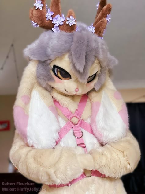 light cream jackalope fursuit with pink tipped ears,light grey fur detailing and brown antlers with purple flowers attached. they've got mustard eyes with pink blushy cheeks, and white tummy fur accents. Bunny Kemono Fursuit, Jackalope Fursona, Bunny Fursona Art, Kawaii Fursona, Moth Fursuit, Deer Fursuit, Cute Fursona, Kawaii Fursuit, Cute Fursuits