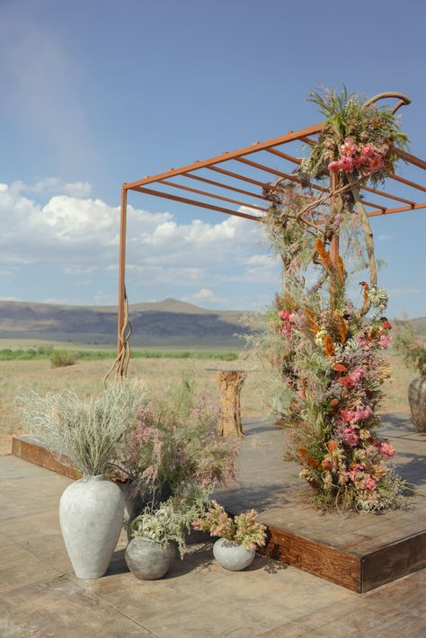 New Mexico Wedding adorned with native florals  Photographer: Samm Blake Desert Wedding Ceremony, Romantic Outdoor Wedding Ceremony, Samm Blake, Romantic Outdoor Wedding, New Mexico Wedding, Outdoor Wedding Inspiration, Metal Arch, Event Branding, Vibrant Flowers