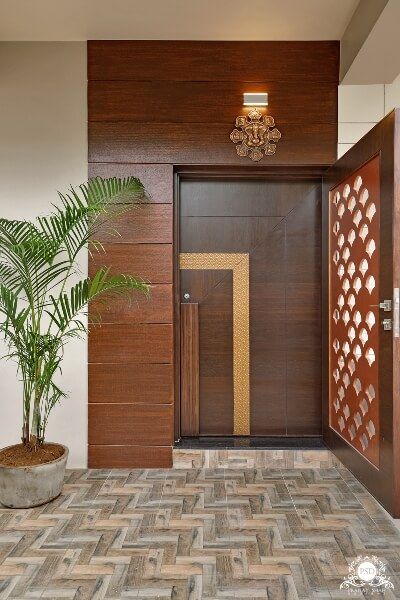 Tiles Near Main Door, Wooden Tiles For Outside House Wall, Main Door Tiles Design, Front Door Wall Tiles Design, Main Door Wall Panelling Design, Mein Wood Door Design, House Main Entry Door Design, Wall Tiles Exterior Front Doors, Main Door Entrance Wall Tiles